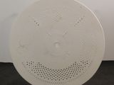 a white plate with holes on it sitting on a table