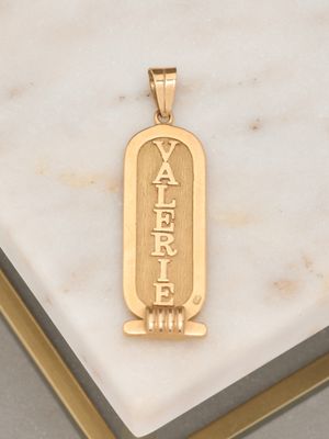 a picture of a gold plated pendant with the word yafer
