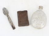 a small bottle and a spoon next to a wallet