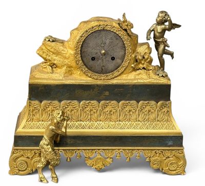 a gold clock sitting on top of a black and gold table
