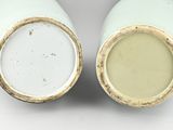 two white vases sitting side by side on a white surface