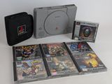 a lot of video games on the table with a case