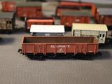 several toy trains are lined up on a table next to each other