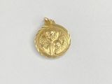 a close up of a gold coin on a white surface