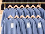 a rack with a lot of shirts on it in a store