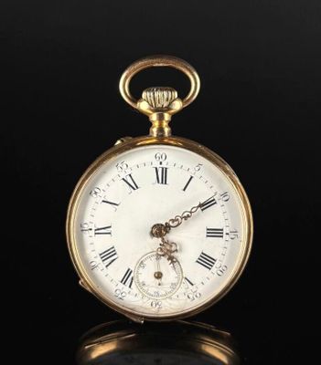 an antique gold pocket watch with roman numerals on the face