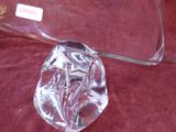 a clear glass object on a red cloth