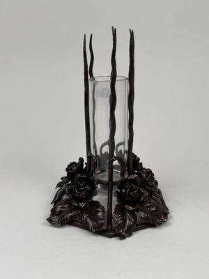 candle holder made of wood and metal with a glass on top