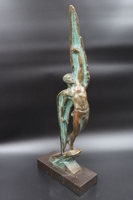 an image of a bronze statue of a man holding a bird