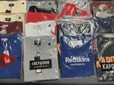 a lot of t - shirts that are on a table
