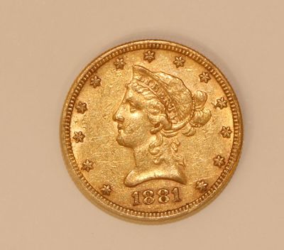 a close up of a gold coin with a woman ' s head on it