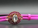 pink leather bracelet with a crystal stone center and a gold clasp
