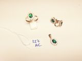 three rings and a necklace are on a table with a price tag