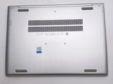 a silver laptop that has a blue sticker on it