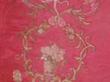 a pink bag with a bird and flowers on it