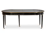 une table à manger ovale avec un plateau noir et des bordures dorées