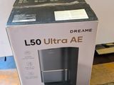 packaging for a l50 ultra ae coffee machine sitting on the floor