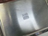 a metal box with a sticker on it sitting on a counter