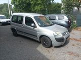 a silver van that is parked in a parking lot