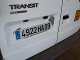 a close up of a white truck with a license plate on it