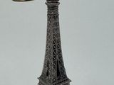 a silver statue of the eiffel tower on a white background