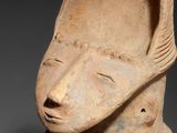 a close up of a statue of a person with a hood on