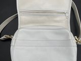 a white purse with a zipper on the inside of it
