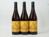 three bottles of beer sitting next to each other on a table