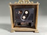 a small wooden box with a radio inside of it