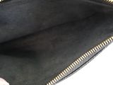 the inside of a black purse with gold zippers on it