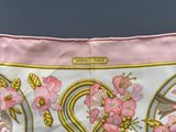 a pink and gold purse with flowers and birds on it