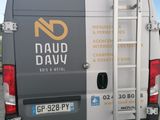 a van that has a ladder on the back of it