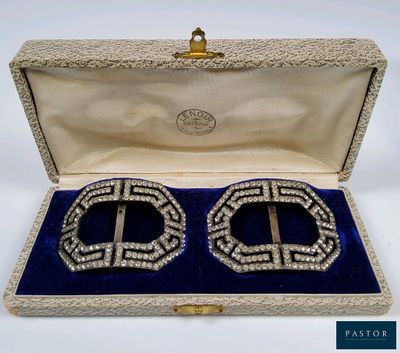 pair of silver and crystal cuff earrings in a velvet case