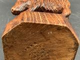 an image of a wooden sculpture of a bird on a log