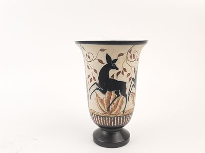 a black and white vase with a picture of a deer on it