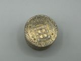a close up of a coin with a coat of arms on it