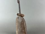 an old bell with a metal handle on a gray surface