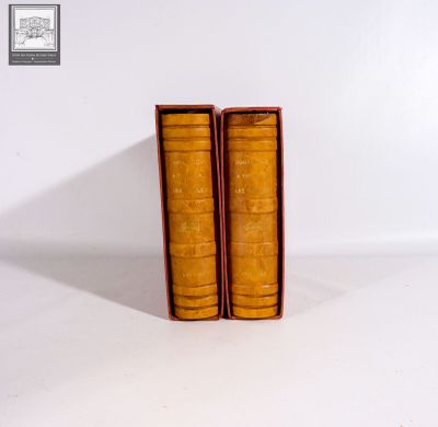 two books that are sitting in a box on a table