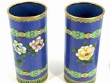 pair of blue vases with floral designs on them on a white surface