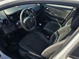 the interior of a car with the door open showing the steering wheel and dashboard