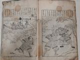 two old books with asian writing on them on a table