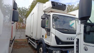 two trucks parked next to each other on the side of the road