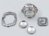 several pieces of silver are arranged on a white surface