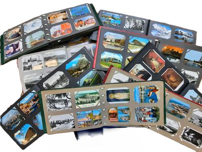 une pile de cartes postales illustrées posées sur une surface blanche