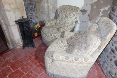 a picture of a living room with two chairs and a fire place