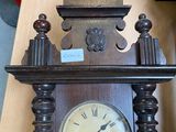 a wooden clock with a horse on top of it