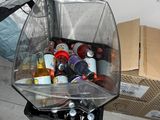 a plastic bag full of bottles and cans on the floor