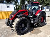 a red tractor that is parked in a parking lot
