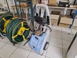 several hoses are lined up on a cart in a room