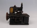 an old sewing machine sitting on a white surface